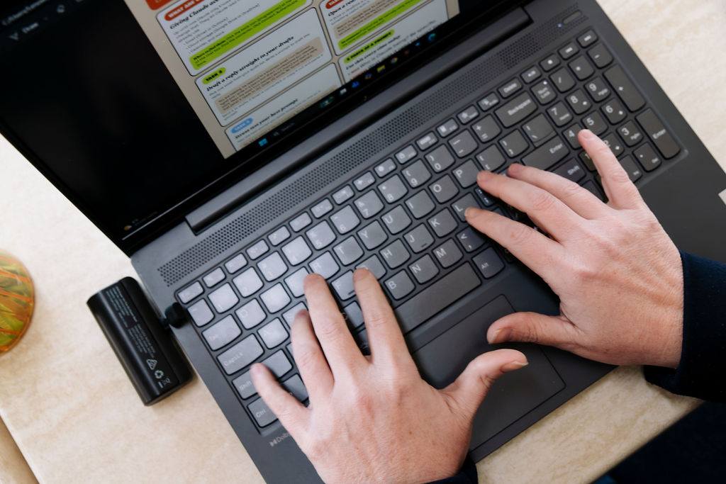 Hands on a laptop keyboard, working with Claude