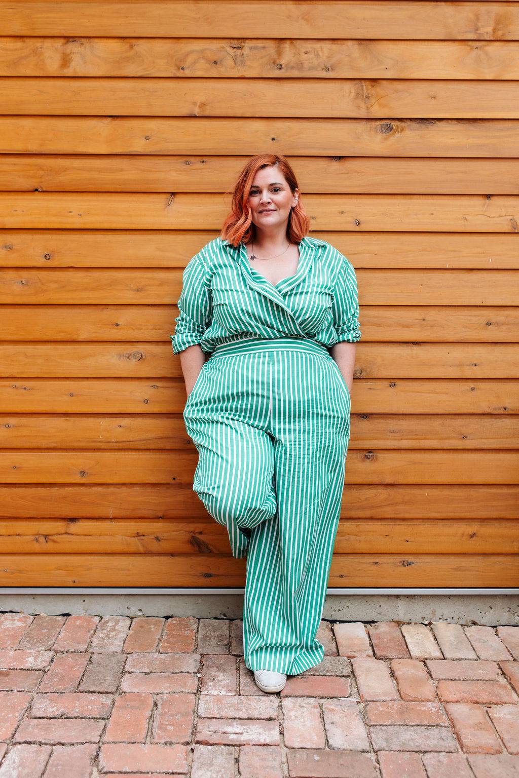 Portrait in a green striped outfit against a timber wall